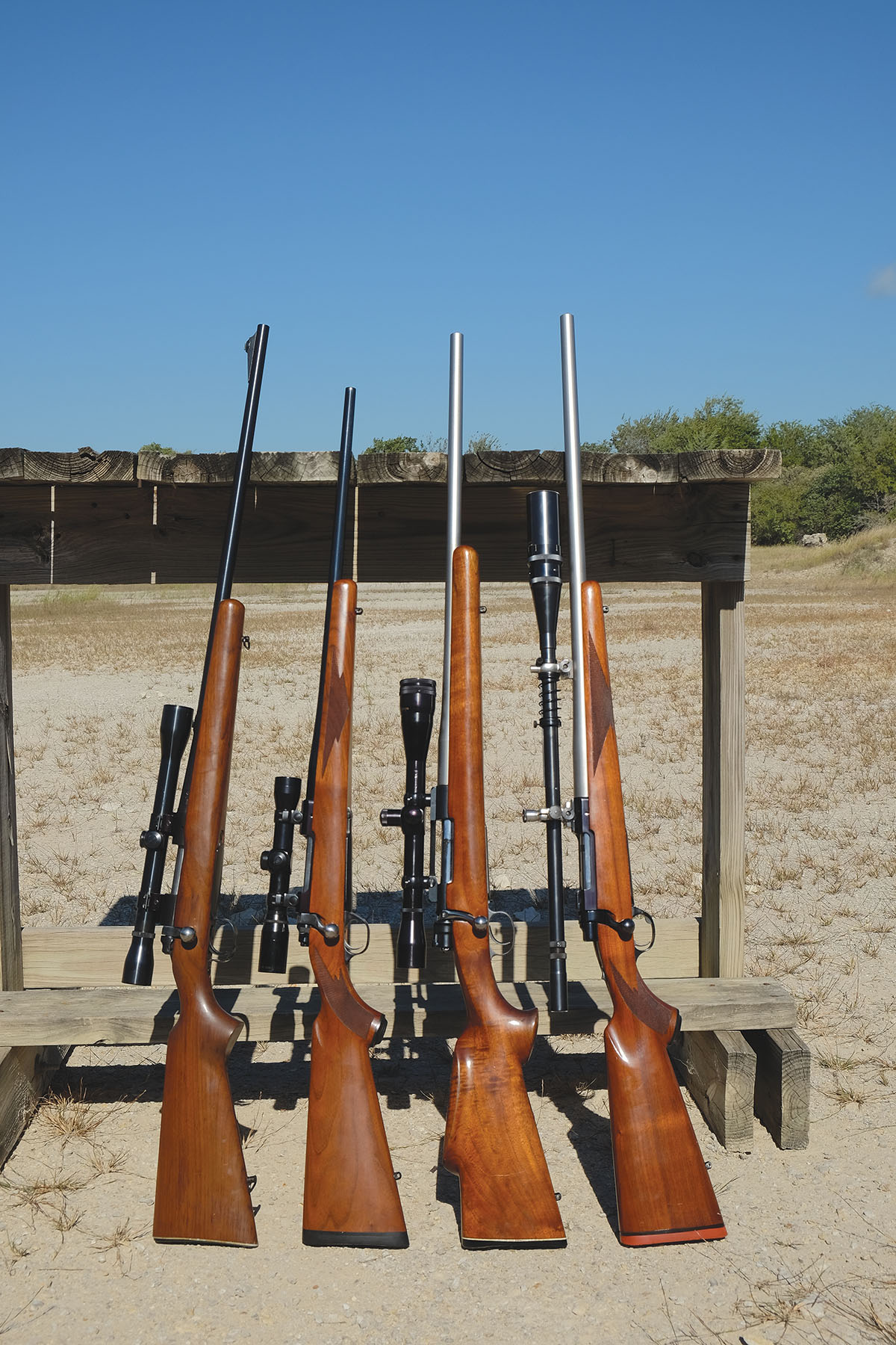 Rifles used for comparison testing of Sierra 50- and 55-grain bullets include, from left: a Remington 722 222 Remington with a 6x Weaver scope, Ruger 77 MK II 223 Remington with a 6x Burris Compact scope, FN Mauser 22-250 Remington with a 6x Lyman Silhouette scope and a Ruger 77V 220 Swift with a 12x Unertl scope.